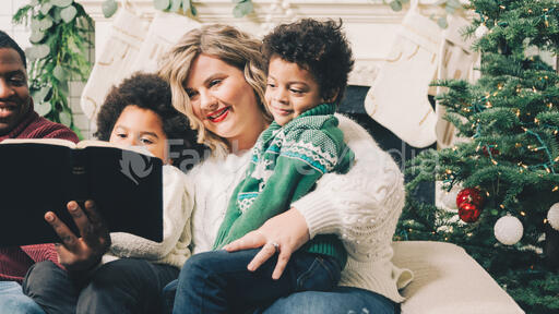 Family Reading the Bible Together at Christmastime