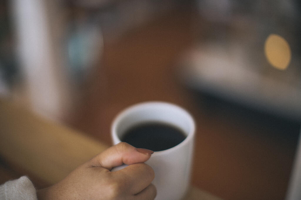 Woman Holding a Cup of Coffee large preview