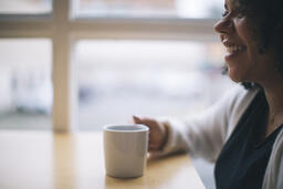 Woman Laughing with a Cup of Coffee  image 2