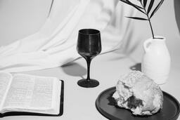 Communion Bread, Wine, Bible and Vase on Table  image 1