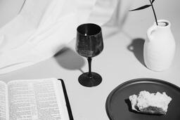 Communion Bread, Wine, Bible and Vase on Table  image 5