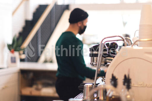 Barista Wearing a Mask and Making Coffee