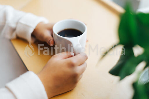 Hands Holding a Cup of Coffee
