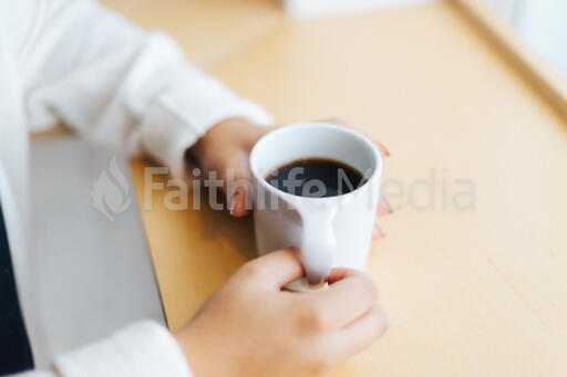 Hands Holding a Cup of Coffee