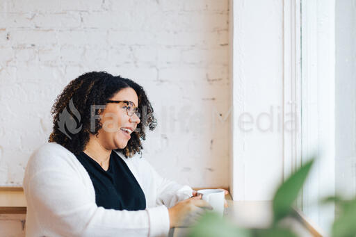 Woman Laughing with a Cup of Coffee