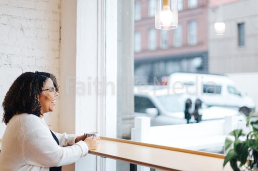 Woman Laughing with a Cup of Coffee