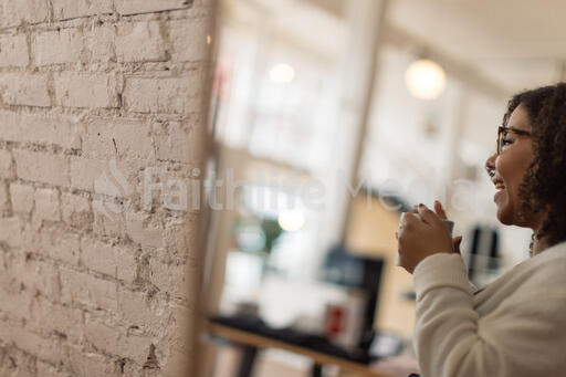 Woman Laughing with a Cup of Coffee