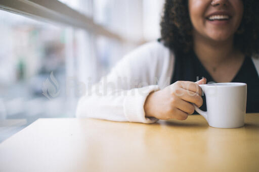 Woman Laughing with a Cup of Coffee