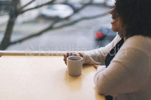 Woman Laughing with a Cup of Coffee