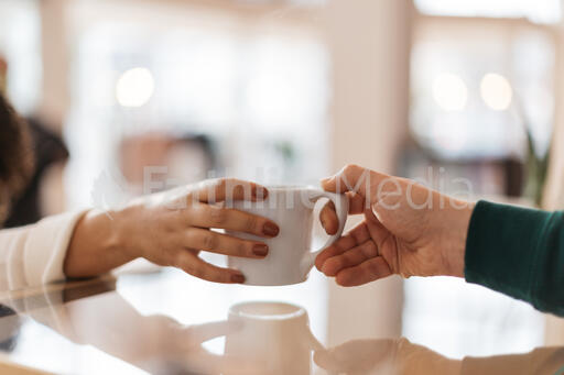 Barista Handing Off a Cup of Coffee to a Customer