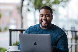 Man Working on Laptop at Coffee Shop  image 2