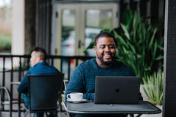 Man Working on Laptop at Coffee Shop  image 6