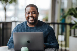 Man Working on Laptop at Coffee Shop  image 4