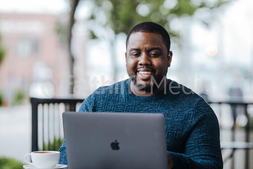 Man Working on Laptop at Coffee Shop