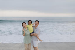 Family Smiling and Laughing on the Beach  image 2