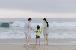 Family Walking Together Toward the Ocean Shore  image 5