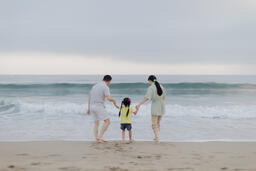 Family Walking Together Toward the Ocean Shore  image 7