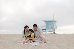 Family Reading the Bible Together on the Beach  image 1