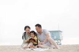 Family Reading the Bible Together on the Beach  image 4