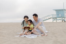 Family Reading the Bible Together on the Beach  image 2