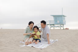 Family Reading the Bible Together on the Beach  image 5