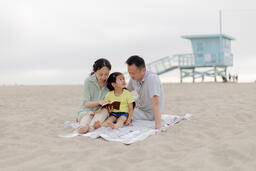 Family Reading the Bible Together on the Beach  image 4
