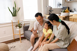 Family Looking at a Smart Phone Together  image 4