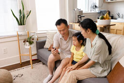 Family Looking at a Smart Phone Together  image 1