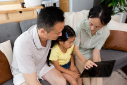 Family Looking at an iPad Together  image 1