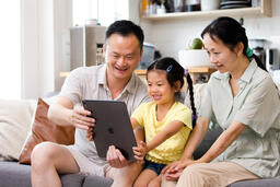 Family Looking at an iPad Together  image 2