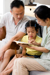 Family Reading the Bible Together at Home  image 1