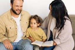 Young Family Reading the Bible Together  image 1