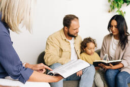Young Family Reading the Bible with an Older Couple  image 5