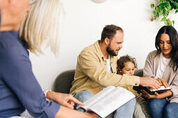 Young Family Reading the Bible with an Older Couple  image 4