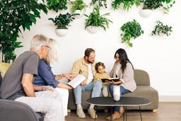 Young Family Reading the Bible with an Older Couple  image 1