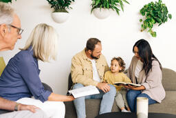 Young Family Reading the Bible with an Older Couple  image 3
