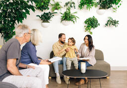 Young Family Reading the Bible with an Older Couple  image 5