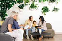 Young Family Reading the Bible with an Older Couple  image 3