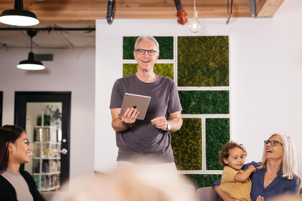 Man Holding an iPad and Leading Small Group large preview