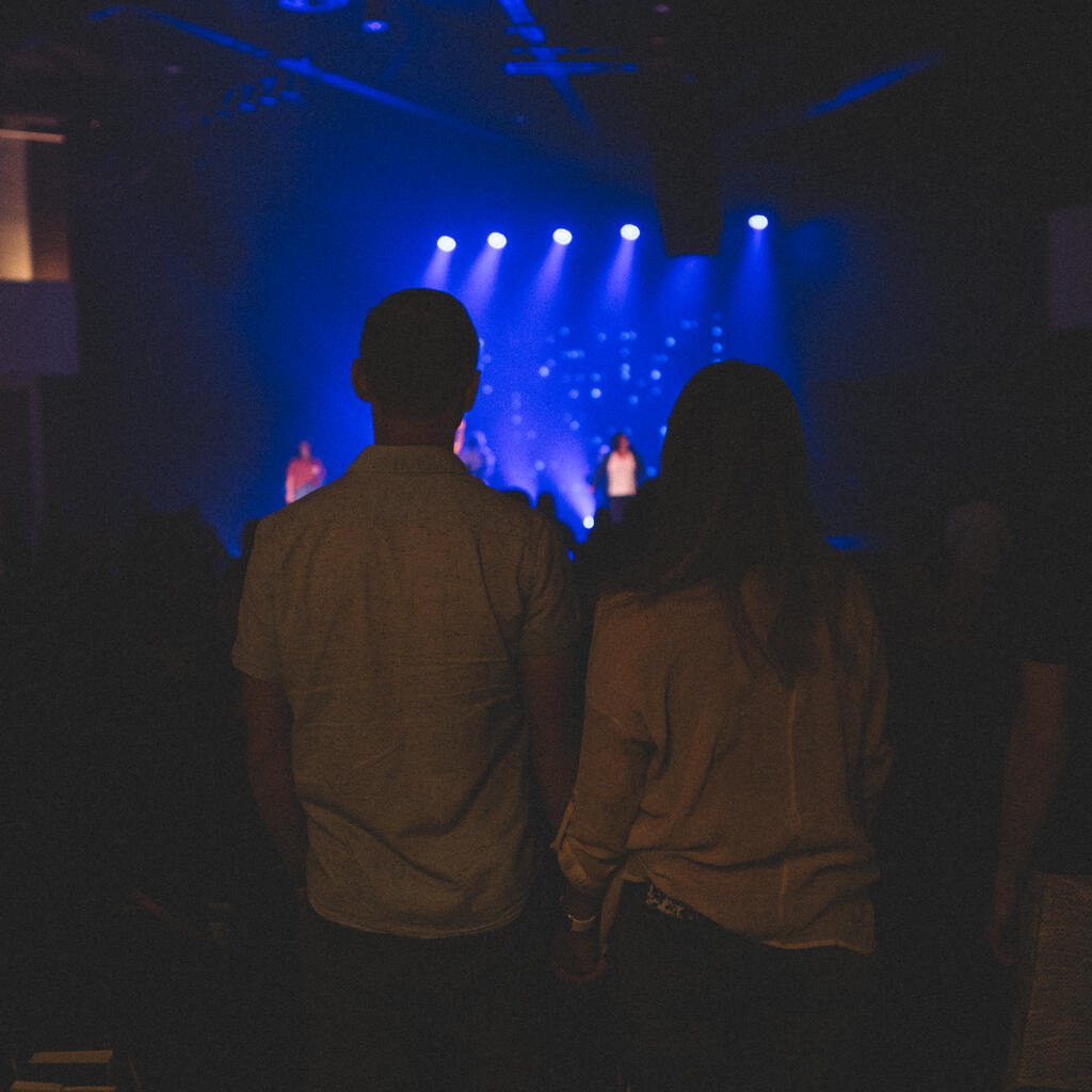 Couple Holding Hands During Worship Service large preview
