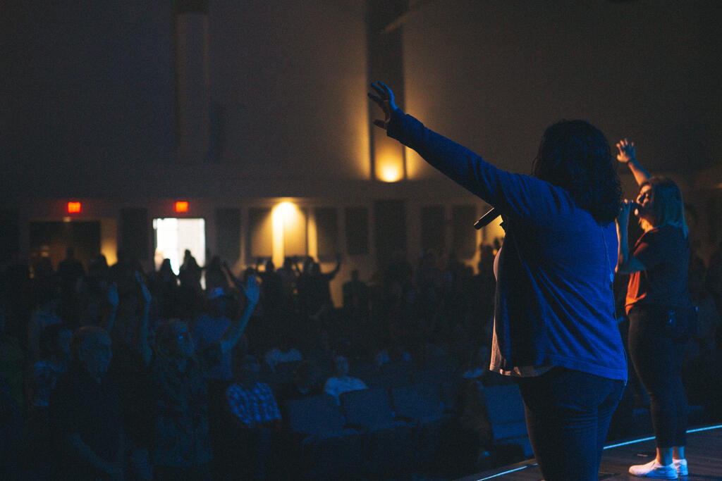 Worship Leader Raising Hand on Stage large preview