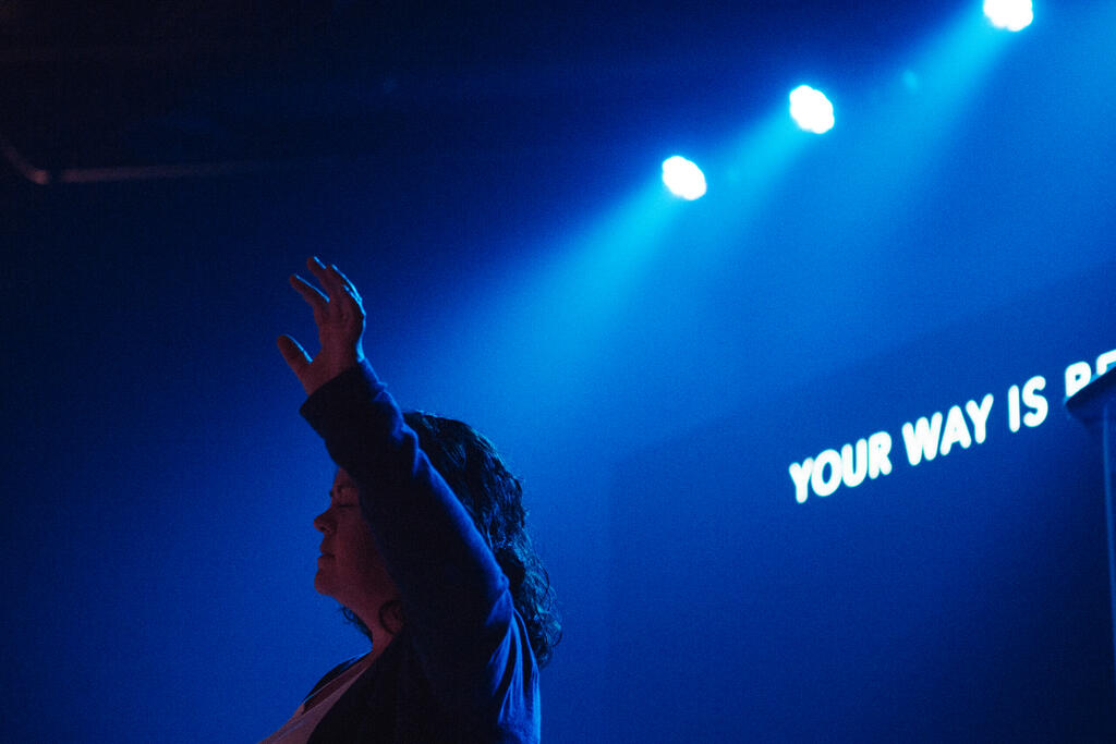 Worship Leader Raising Hand on Stage large preview