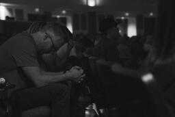 Man Bowing Head in Prayer During Church Service  image 2