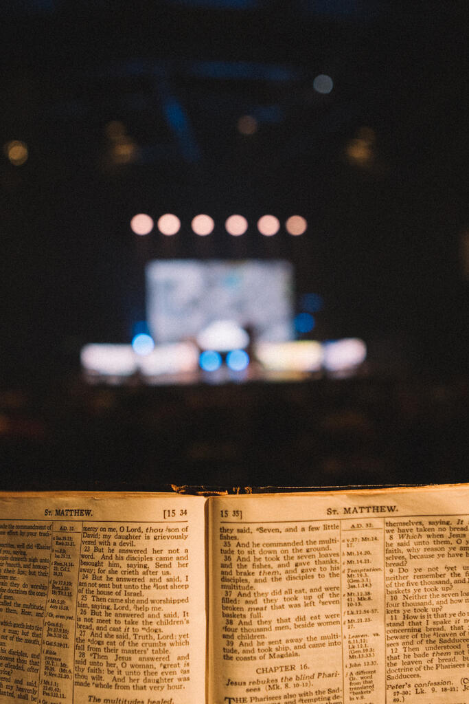 Bible Open to the Book of Matthew with Stage Lights Behind large preview