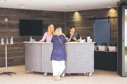 Woman Talking to Volunteers at Info Desk  image 1