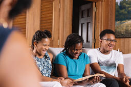 Siblings Doing Devotions and Laughing Together  image 2