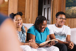 Siblings Doing Devotions and Laughing Together  image 1