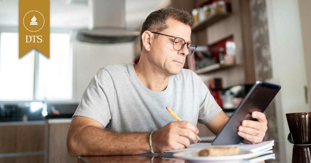 Man studying the Bible at his home office