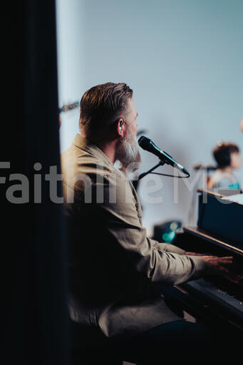 Worship Leader Singing and Playing Piano