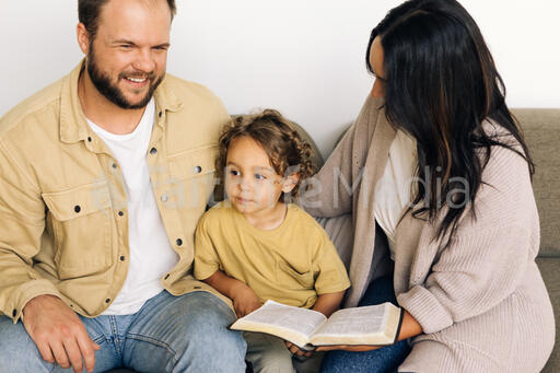 Young Family Reading the Bible Together